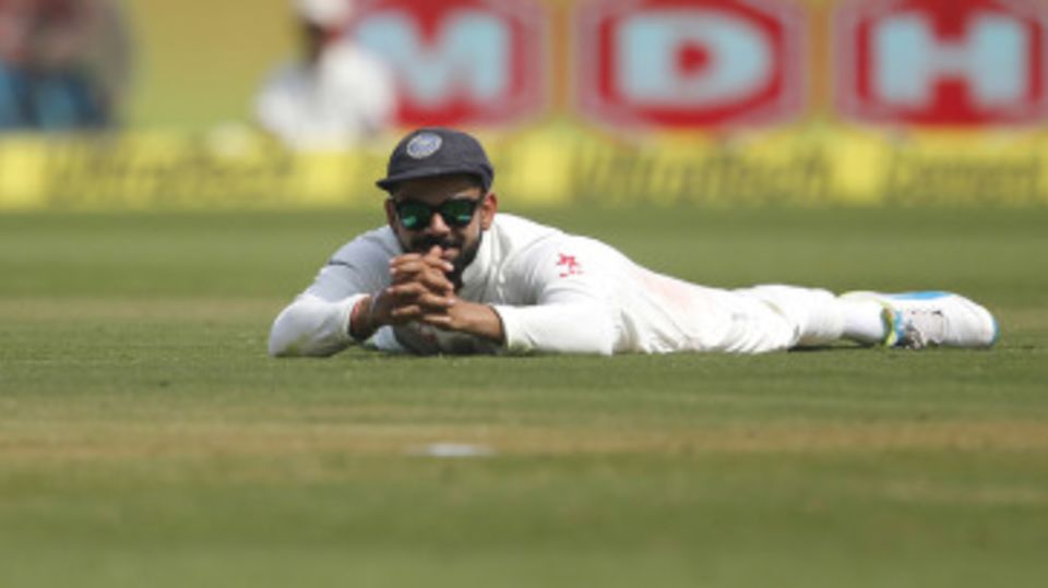 Virat Kohli watches on after a misfield
