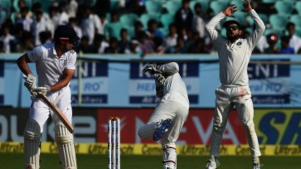 Alastair Cook watches on as Wriddhiman Saha collects one that bounced extra