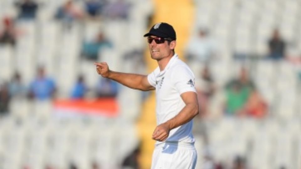The England captain Alastair Cook adjusts his fielders