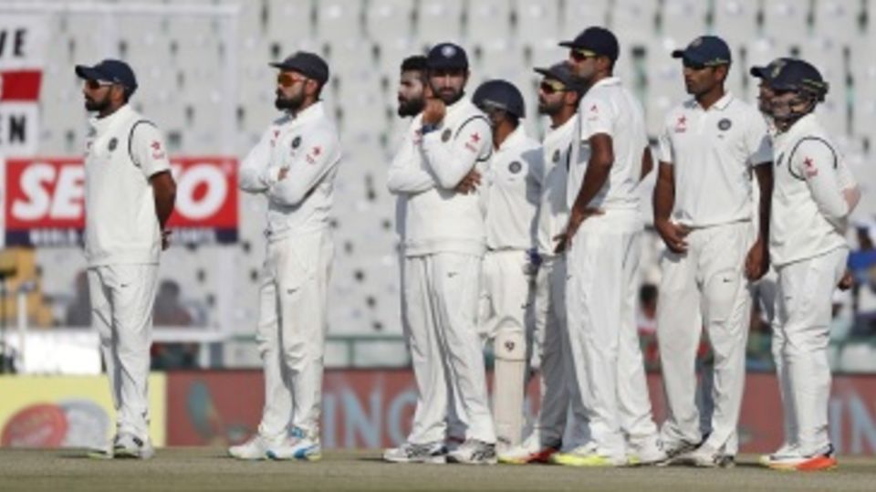 India's players wait on after reviewing a not-out decision
