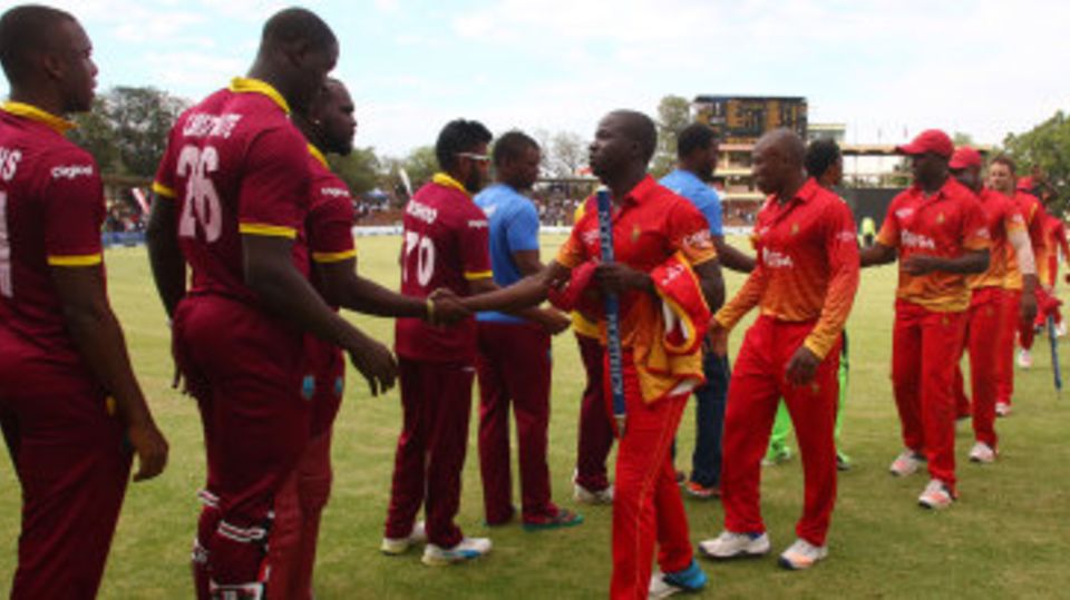 West Indies and Zimbabwe players shake hands after a tie