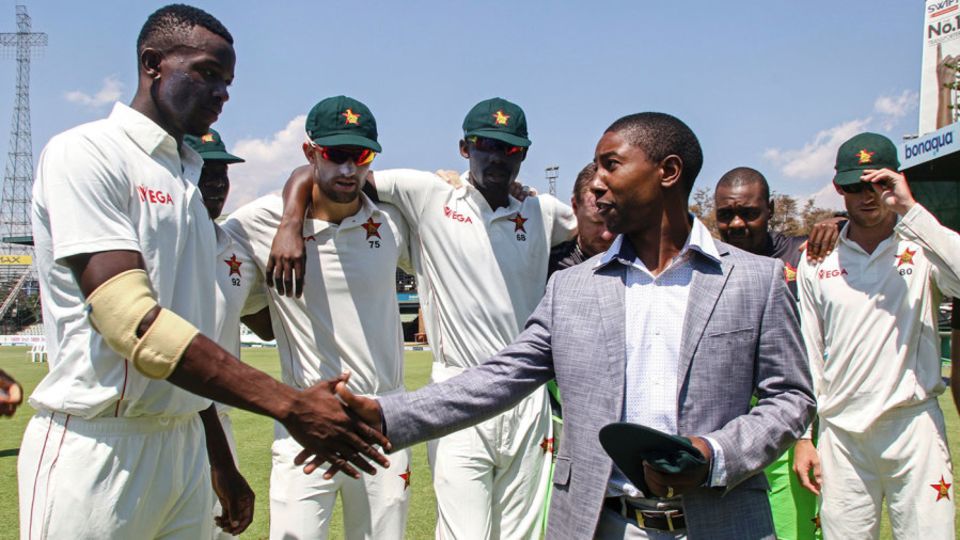 Fast bowler Carl Mumba receives his Zimbabwe Test cap from former captain Tatenda Taibu