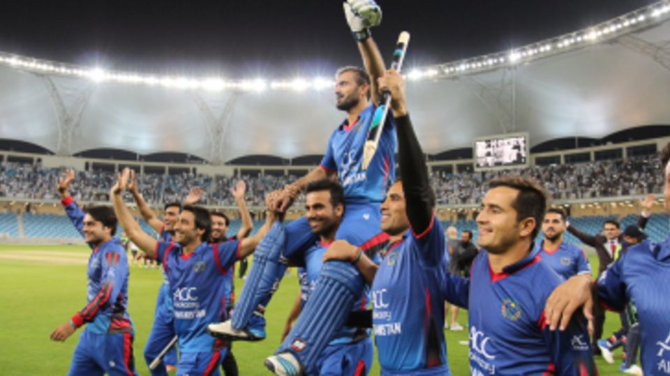 Team-mates carry Nawroz Mangal on a victory lap
