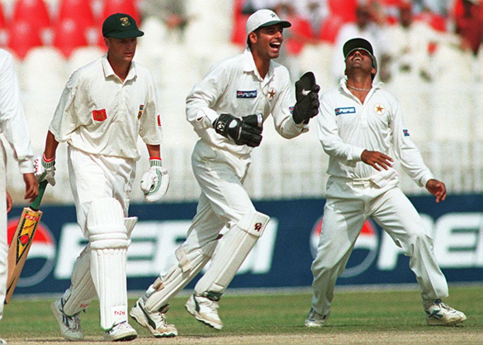 Wasim, as a substitute keeper for Moin Khan, celebrates the dismissal of Gary Kirsten in Rawalpindi, 1997-98
