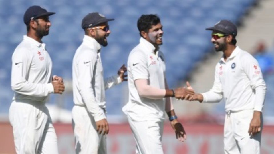 Umesh Yadav is congratulated by Ajinkya Rahane, Virat Kohli and Cheteshwar Pujara