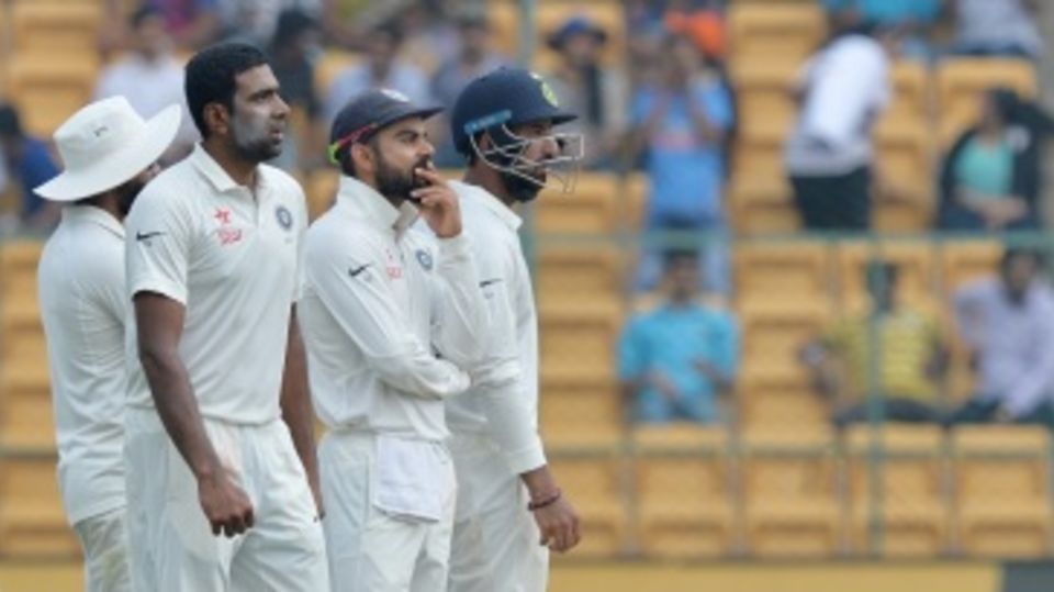 R Ashwin, Virat Kohli and Cheteshwar Pujara wait on a DRS review