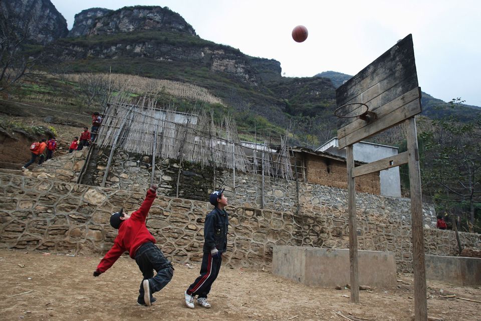 Kids play basketball in a village in the Sichuan province of China