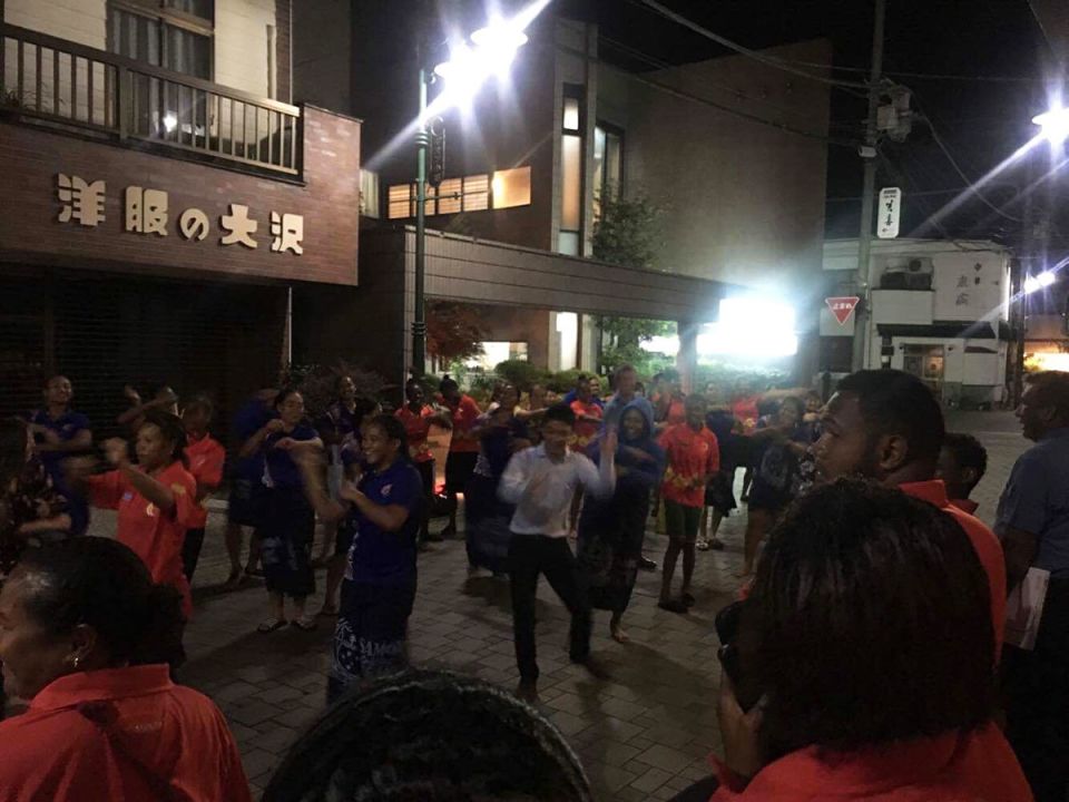 Players and volunteers dance to celebrate the end of the tournament