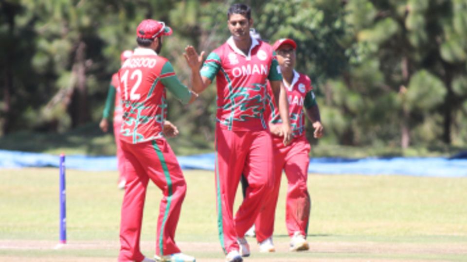 Khawar Ali gets high-fived after taking the wicket of Ibrahim Khaleel