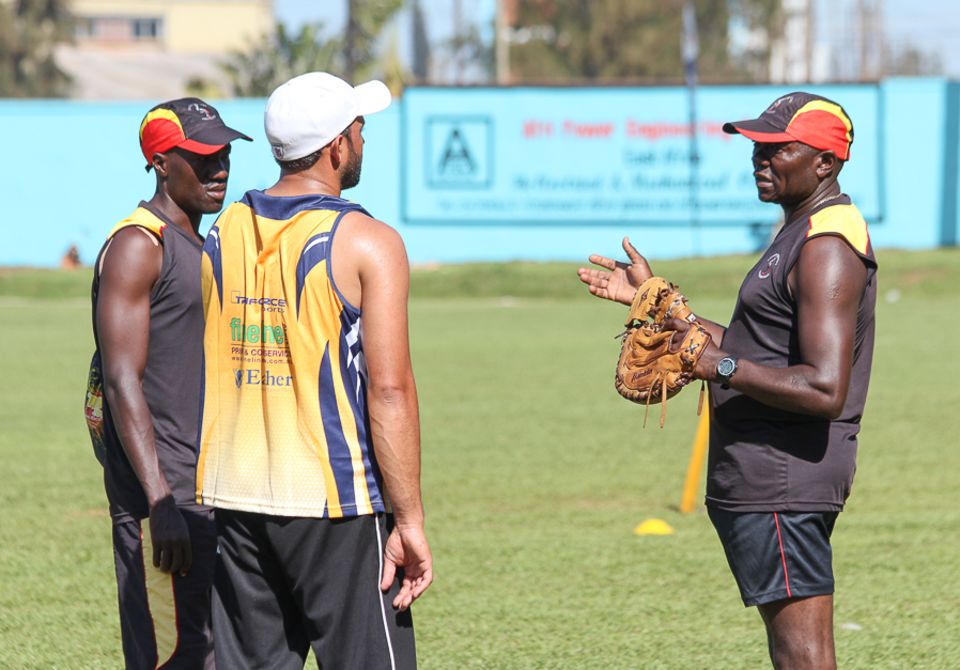 Tikolo talks to Frank Nsubuga (left) and Mohammed Irfan at a training session
