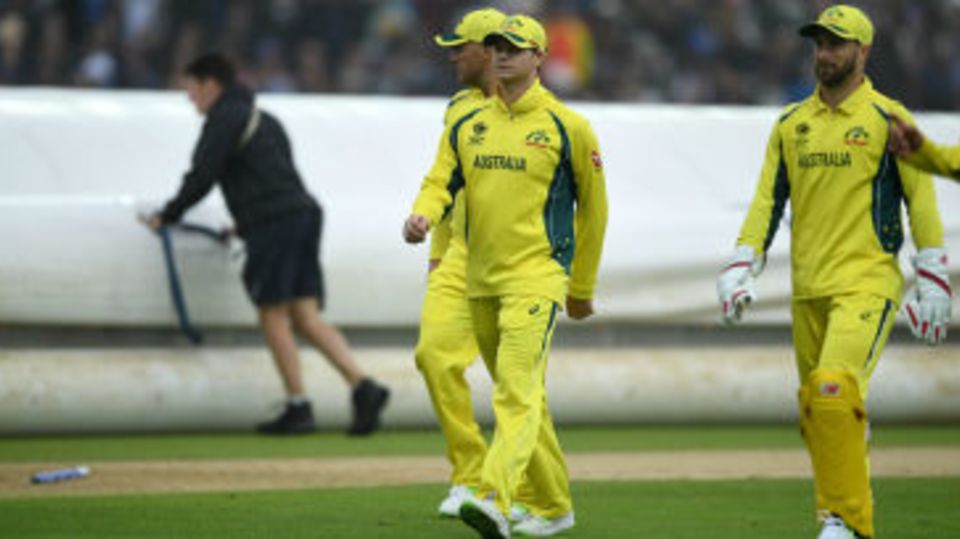 Australia's momentum was checked when rain interrupted with England three-down