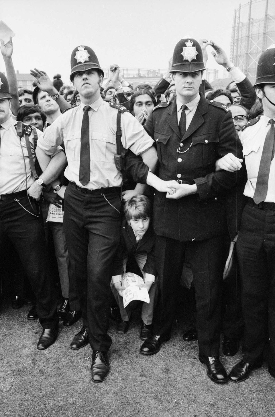 Policemen hold back the crowd after India's win (no, that's not the author trying to sneak past between two of them)