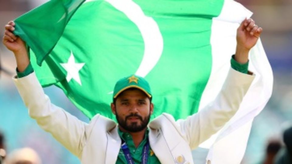 Azhar Ali holds the Pakistan flag aloft after their win in the final