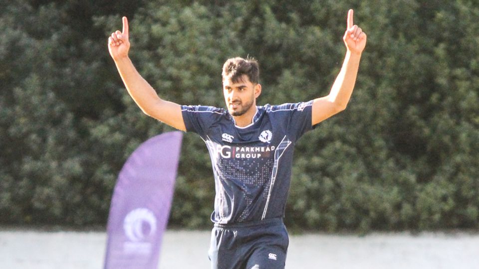 Safyaan Sharif holds his arms aloft after taking the final wicket