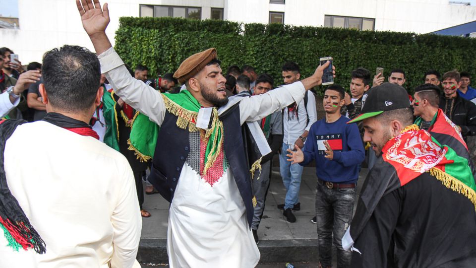 Afghanistan fans dance in the streets outside Lord's before the start of play