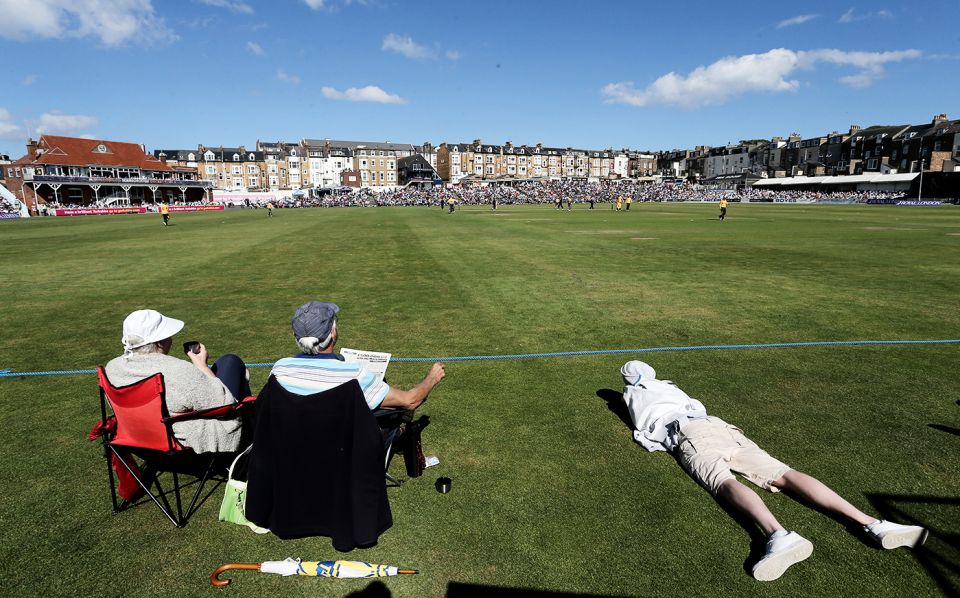 Spectators enjoy a summer afternoon on the boundary's edge in Scarborough, Yorkshire