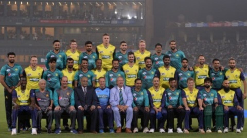 Players from both teams get together for a photo before the start of play