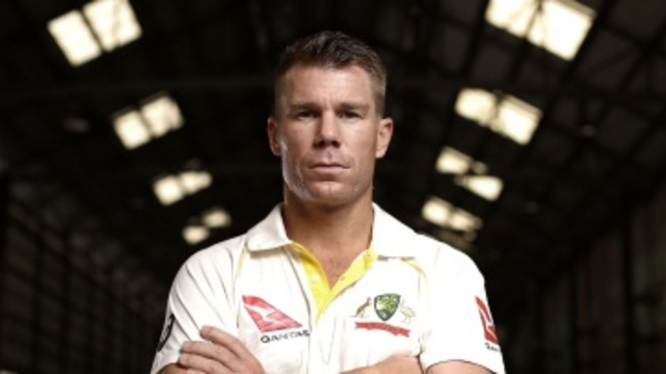David Warner poses in Australia's new Test kit at a promotional event