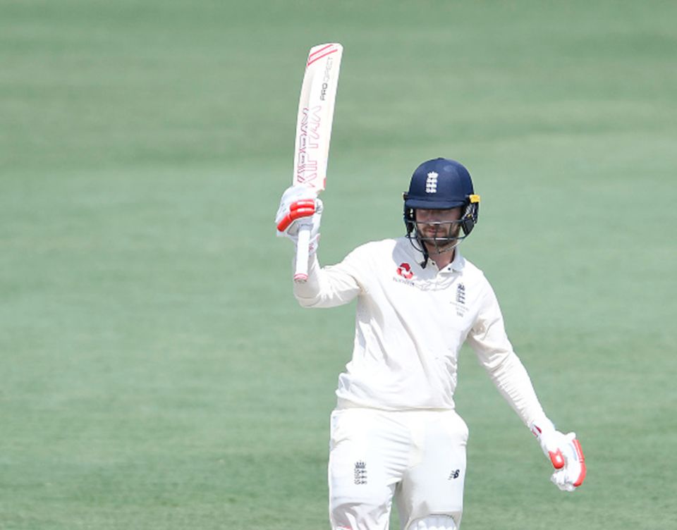 Mark Stoneman raises his bat after bringing up his century
