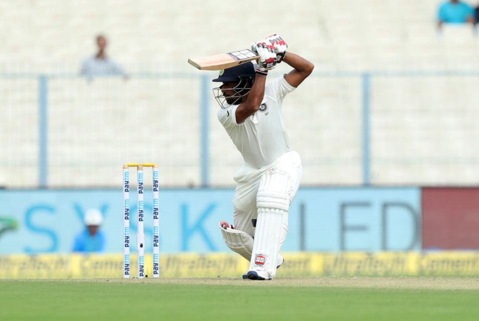 Wriddhiman Saha drives through the off side