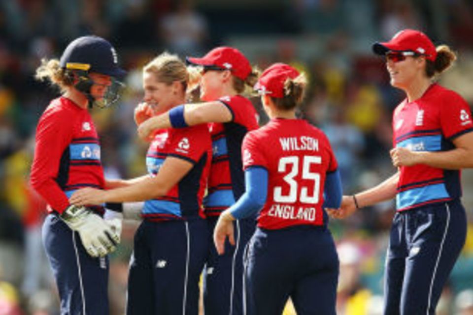 Katherine Brunt is mobbed by her team-mates