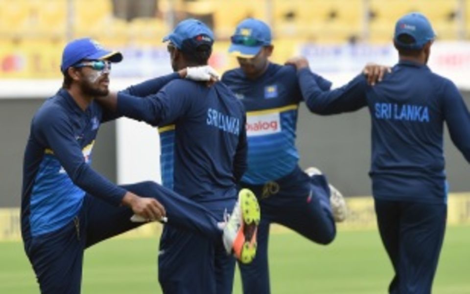 Dinesh Chandimal and his team-mates go through some streches