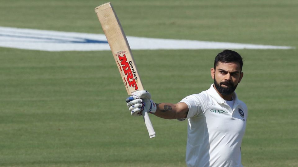 Virat Kohli raises his bat after getting his century