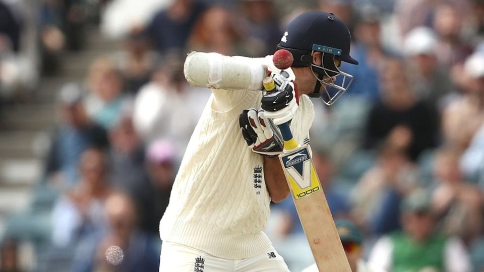 England's No 11 James Anderson takes a blow on the helmet