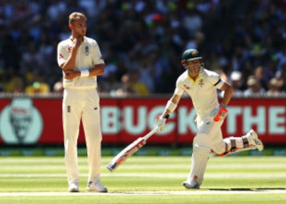 Stuart Broad looks on as David Warner adds to his total