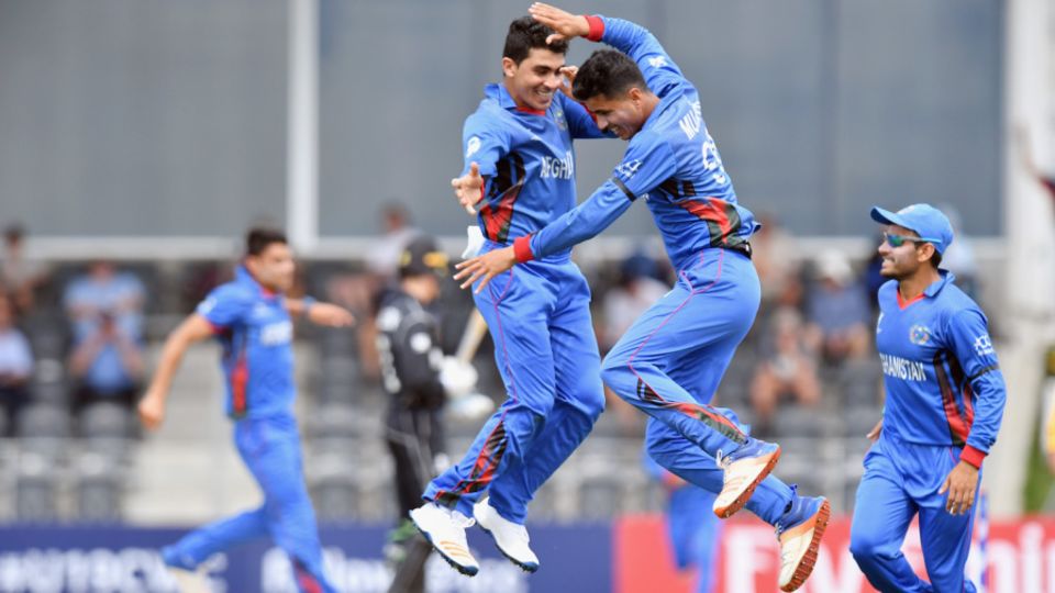 Mujeeb Zadran (right) is thrilled after taking a wicket