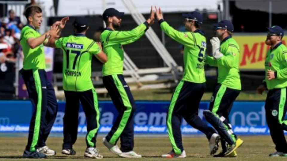 The Ireland players get together after the wicket of Virat Kohli