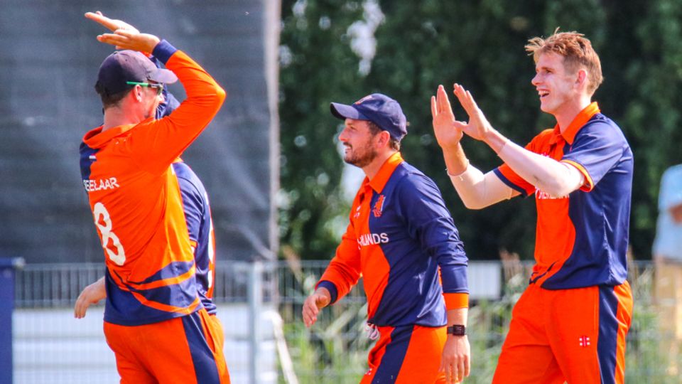 Fred Klaassen gets high-fived by captain Pieter Seelaar after taking a key wicket