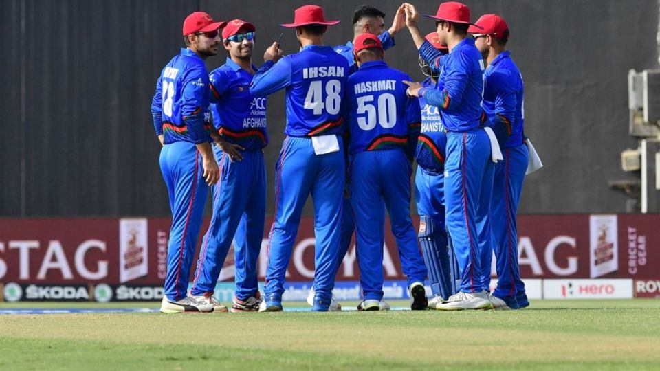 Mujeeb Ur Rahman is mobbed by his team-mates