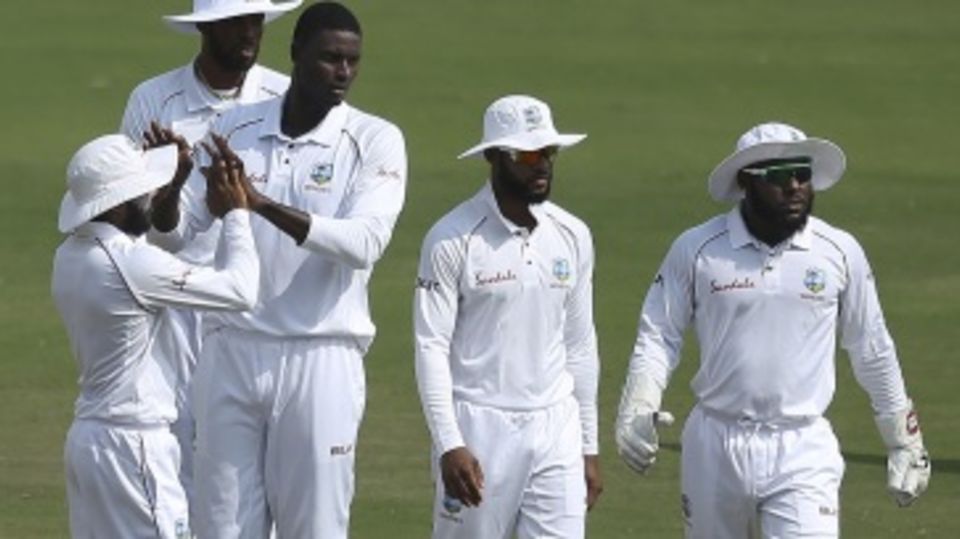 Jason Holder celebrates a wicket