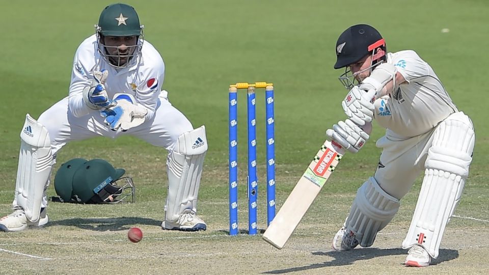 Kane Williamson forces a ball through the off side as Sarfraz Ahmed looks on