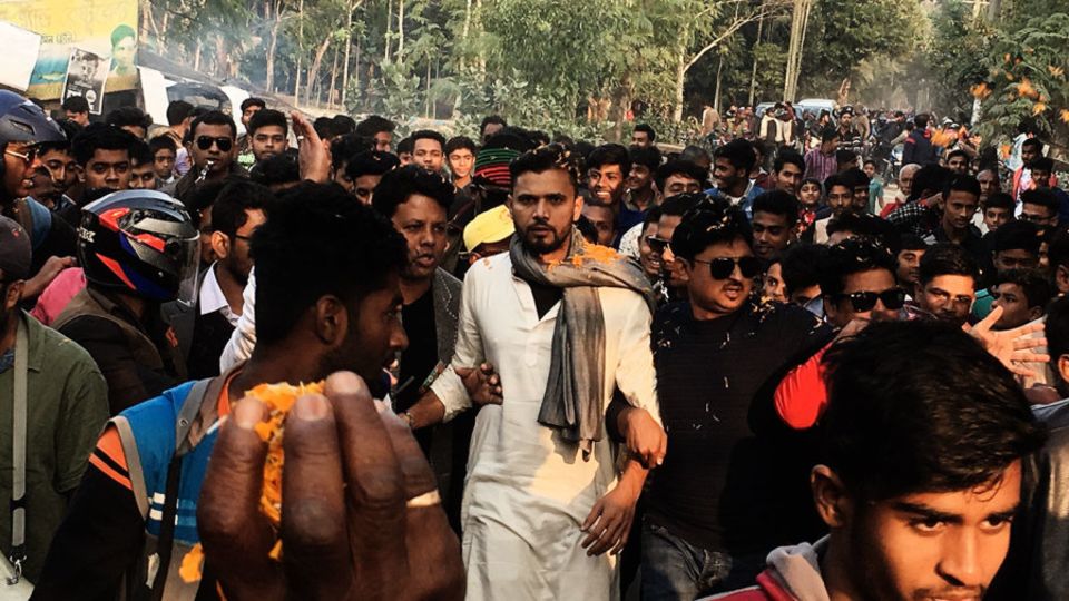 Mashrafe Mortaza walks with supporters during his election campaign