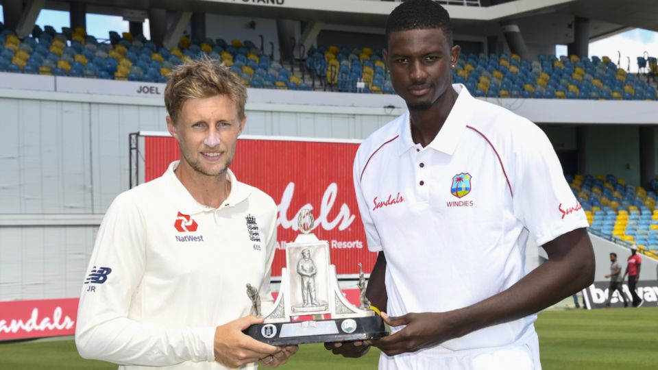 Captains Jason Holder and Joe Root with the Wisden Trophy