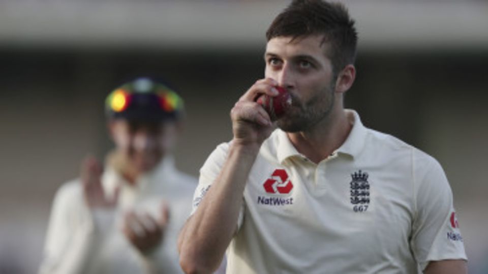 Mark Wood walks off with the match ball after his five-wicket haul