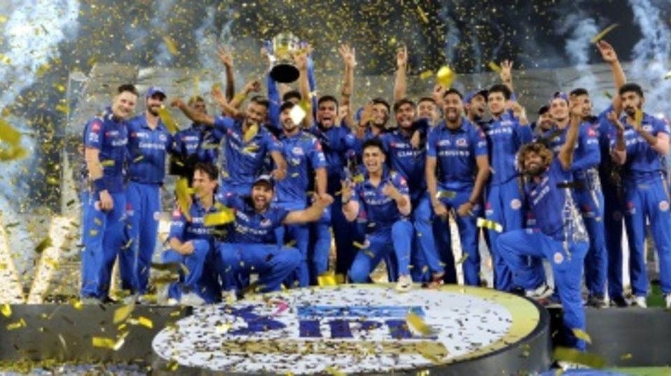 The Mumbai Indians players pose with the IPL 2019 trophy
