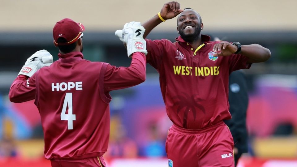 Andre Russell celebrates with Shai Hope