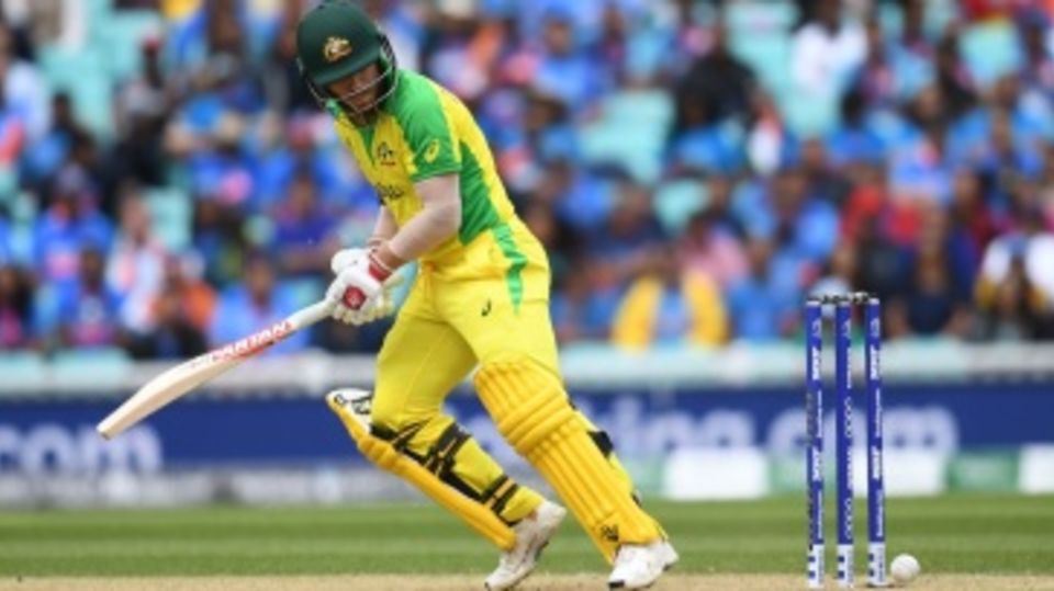 David Warner looks on as the ball hits the stumps but fails to dislodge the bails