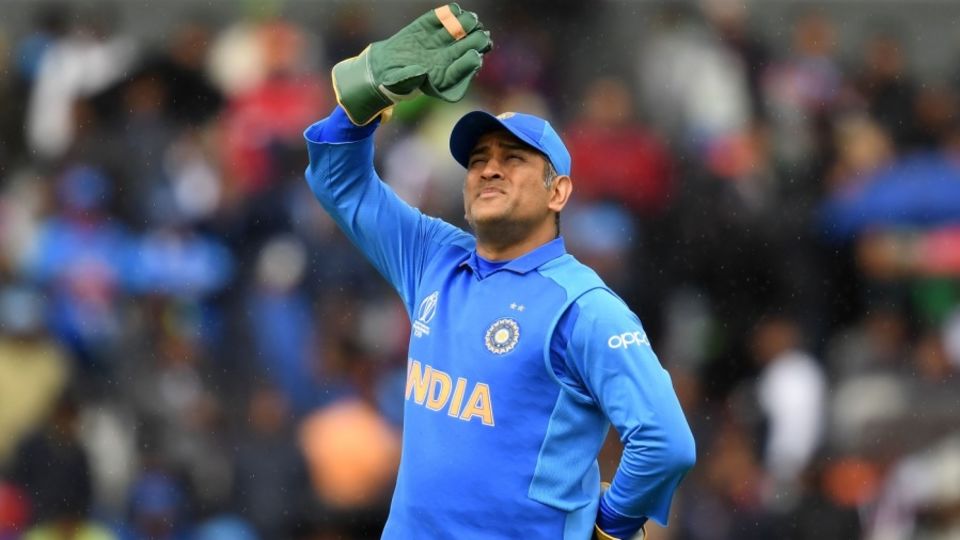 MS Dhoni looks up as light drizzle continues