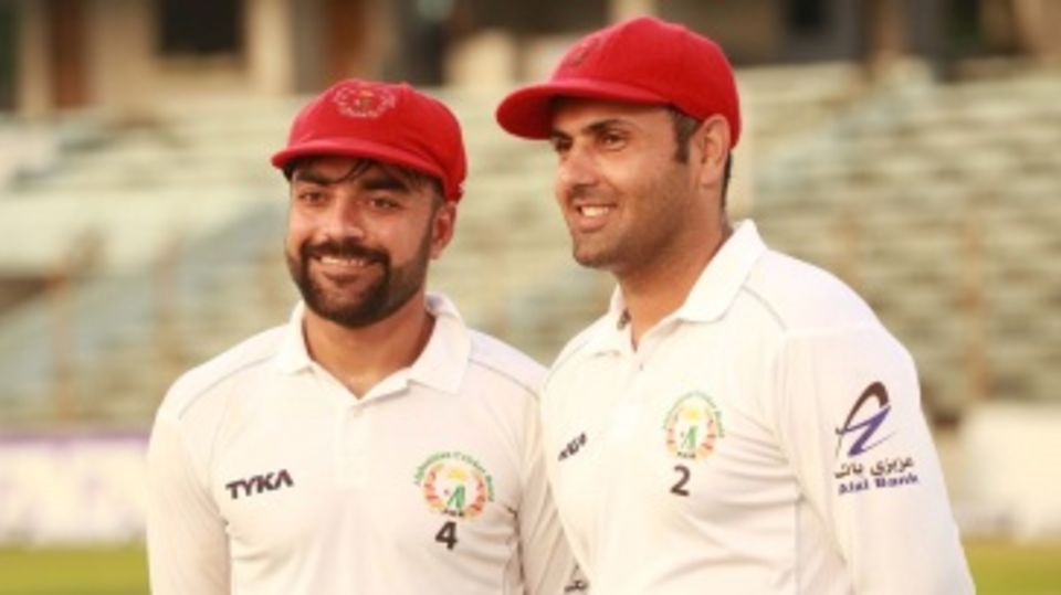 Smile while you're winning - Rashid Khan and Mohammad Nabi after the Test victory