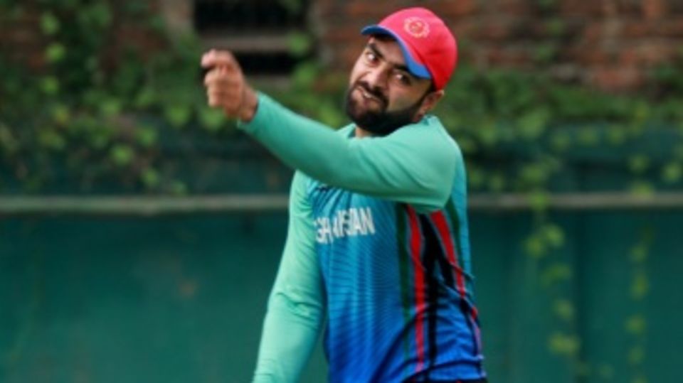 Rashid Khan grimaces while bowling in the nets on the eve of the final