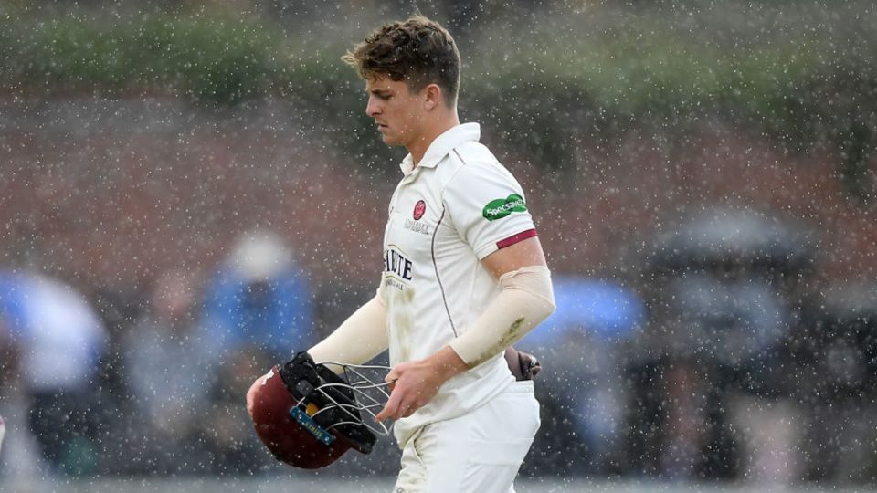 Tom Abell of Somerset walks off as play is delayed due to rain