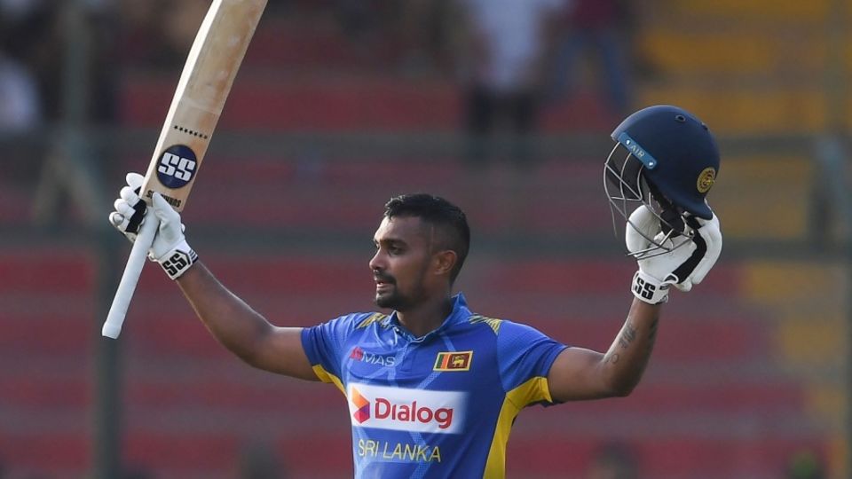 Danushka Gunathilaka raises his bat after getting to hundred