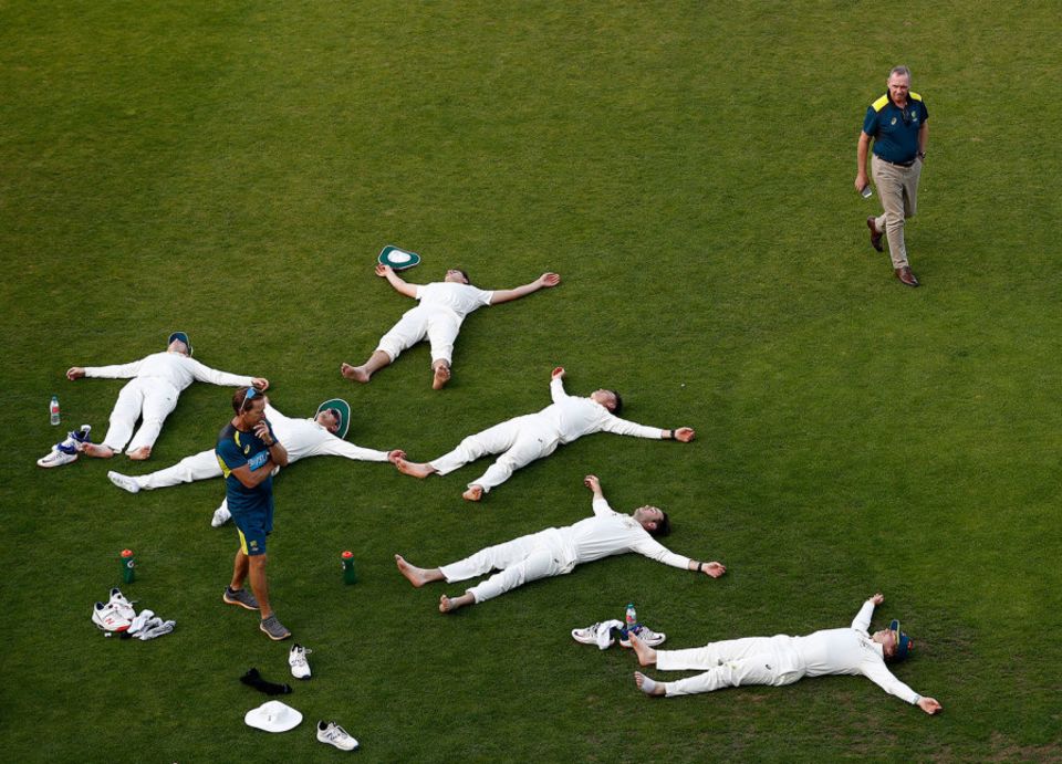 Who's for the chop? Hohns surveys Australia's cricketers as they lie on the turf during the pre-Ashes warm-up game in Southampton