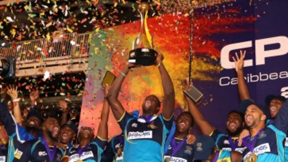 The Barbados Tridents players celebrate with the CPL trophy