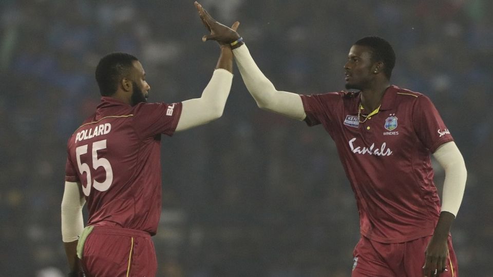 Kieron Pollard and Jason Holder celebrate