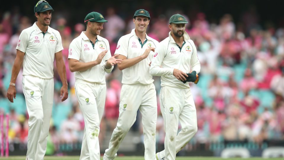 Nathan Lyon is applauded by his fellow bowlers